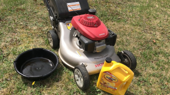 Honda Mower with oil pan and oil beside it